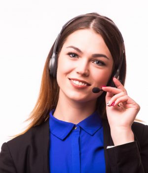 a smiling young customer service girl with a headset at her workplace